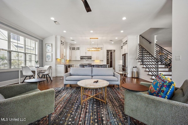 living room featuring dark wood-type flooring and a chandelier