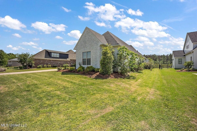 view of side of property featuring a yard