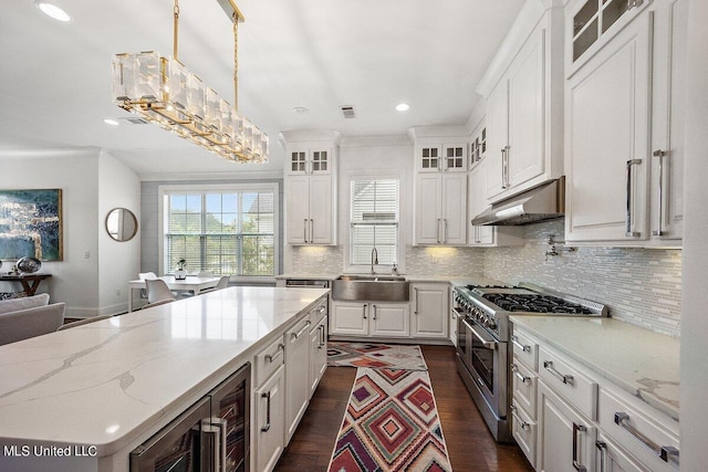 kitchen featuring a kitchen island, range with two ovens, pendant lighting, white cabinets, and dark hardwood / wood-style flooring