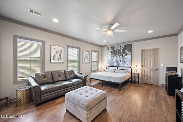 bedroom featuring crown molding, hardwood / wood-style floors, and ceiling fan