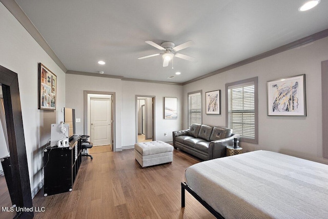 bedroom with ornamental molding, wood-type flooring, and ceiling fan