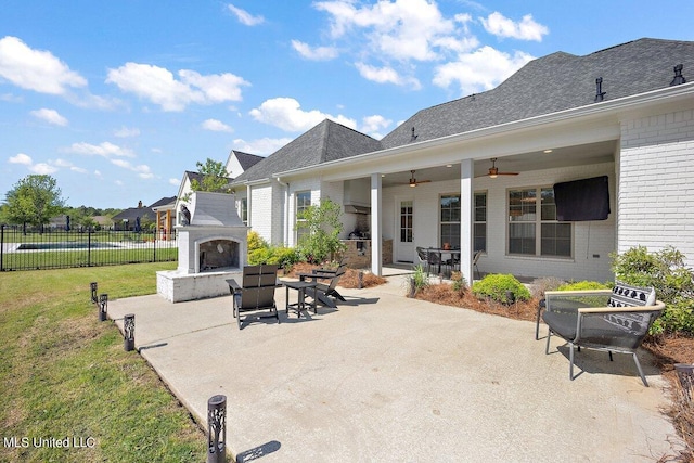 view of patio / terrace with exterior fireplace and ceiling fan