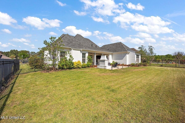 rear view of property with a patio and a yard