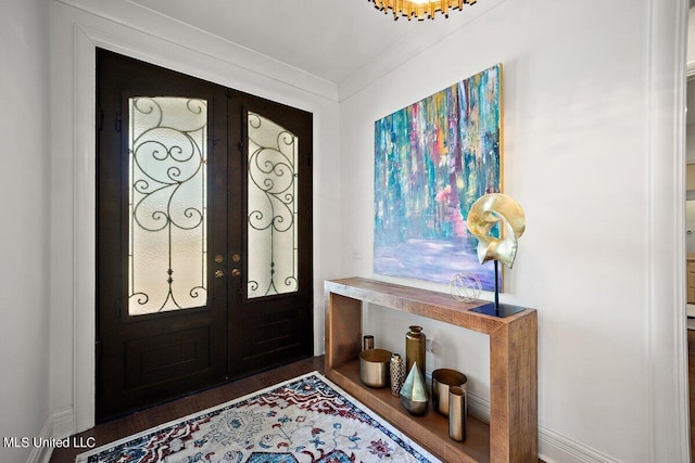 foyer entrance with french doors and dark hardwood / wood-style flooring