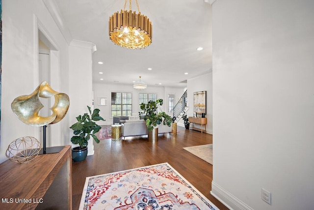 foyer entrance featuring dark hardwood / wood-style flooring and an inviting chandelier