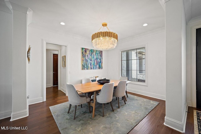 dining area with ornamental molding, an inviting chandelier, and dark hardwood / wood-style floors