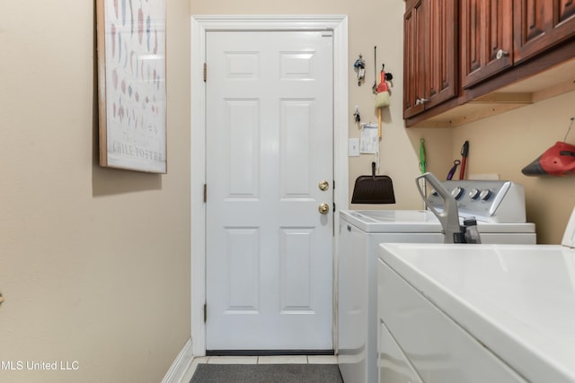 2325 Rue Beaux Chenes, Ocean Springs, MS 39564 - laundry area with washing machine and clothes dryer, light tile patterned floors, cabinet space, and baseboards