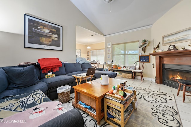2325 Rue Beaux Chenes, Ocean Springs, MS 39564 - living room featuring lofted ceiling, light tile patterned floors, ornamental molding, and a glass covered fireplace