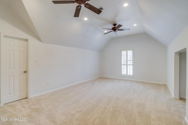 bonus room with vaulted ceiling and light colored carpet