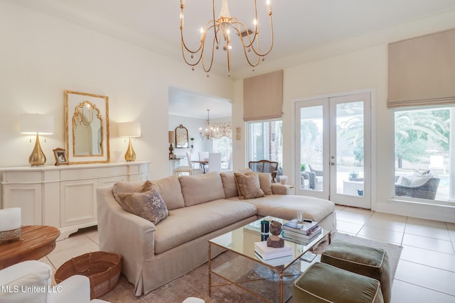 tiled living room with an inviting chandelier and french doors