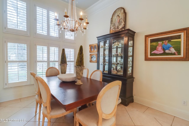 tiled dining space with crown molding, plenty of natural light, and a chandelier