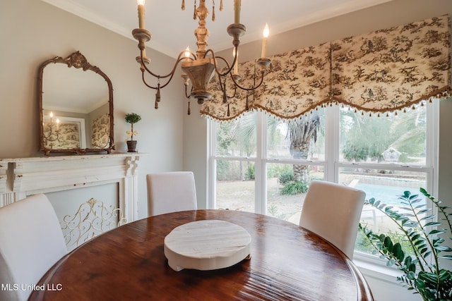 dining area featuring ornamental molding and a chandelier