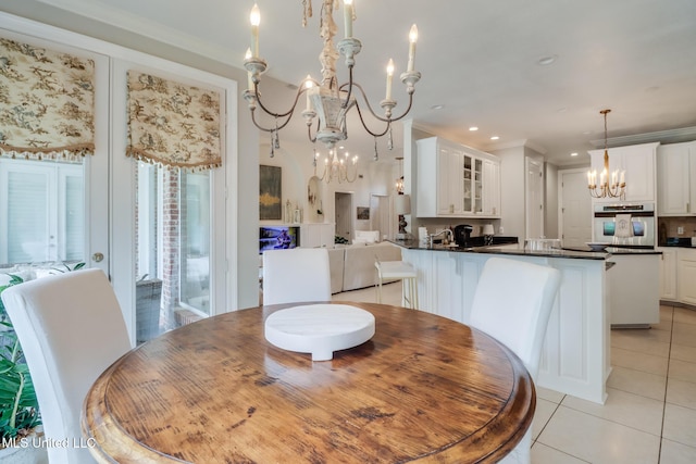 dining room featuring light tile patterned flooring, crown molding, and a notable chandelier