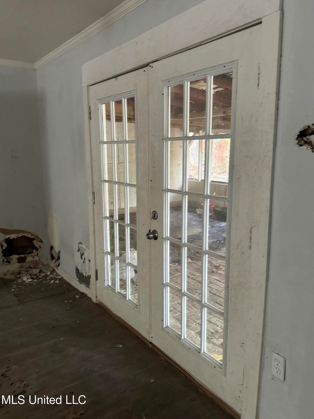 doorway with french doors and crown molding