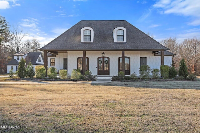 french country style house with french doors, covered porch, and a front lawn