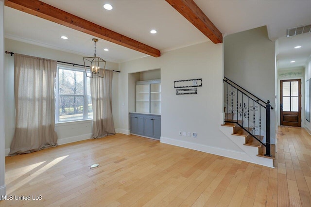 interior space with light wood-type flooring, beam ceiling, and a notable chandelier