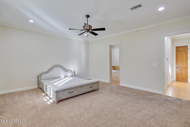 bedroom featuring ceiling fan, light carpet, ornamental molding, and ensuite bath