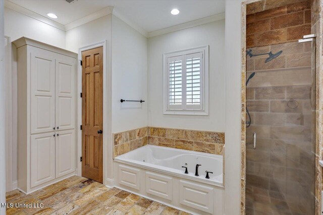 bathroom with ornamental molding and separate shower and tub