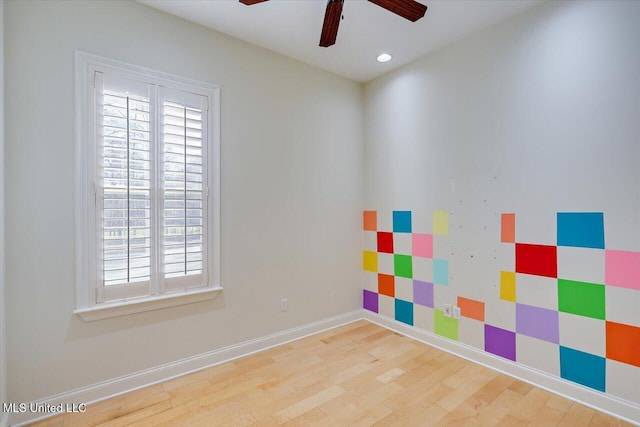 spare room with ceiling fan and hardwood / wood-style floors