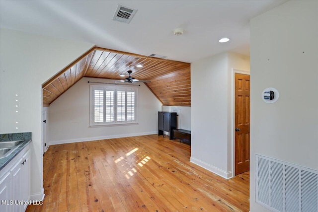 additional living space featuring wooden ceiling, ceiling fan, vaulted ceiling, and light hardwood / wood-style flooring