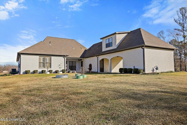 back of property featuring a yard