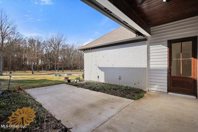 view of side of property featuring a patio area and a yard