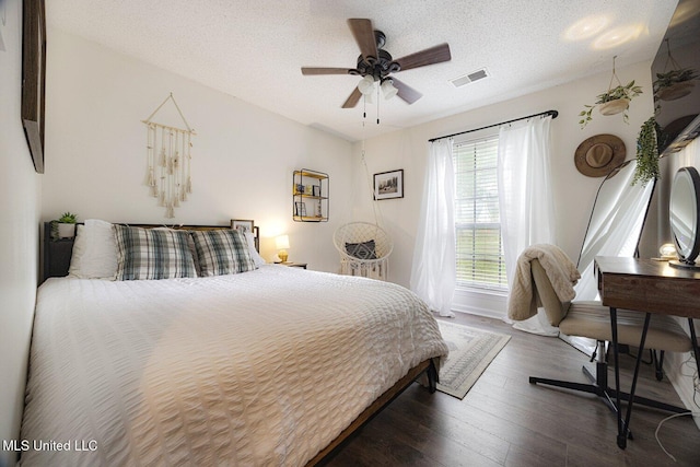 7101 Blue Grass Rd, Olive Branch, MS 38654 - bedroom featuring dark wood-style flooring, a textured ceiling, and ceiling fan