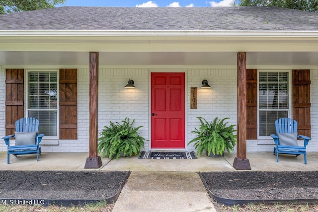 7101 Blue Grass Rd, Olive Branch, MS 38654 - entrance to property with brick siding, a porch, and roof with shingles