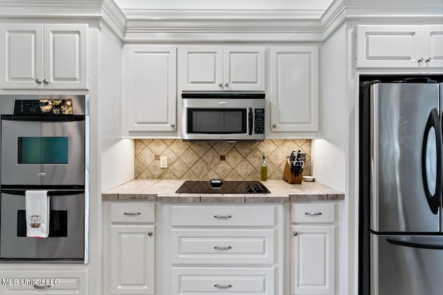 103 Maple Grv, Madison, MS 39110 - kitchen with appliances with stainless steel finishes, white cabinetry, and decorative backsplash