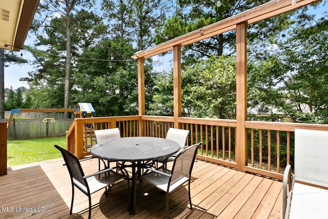 103 Maple Grv, Madison, MS 39110 - wooden terrace with outdoor dining space, a playground, a fenced backyard, and view of wooded area