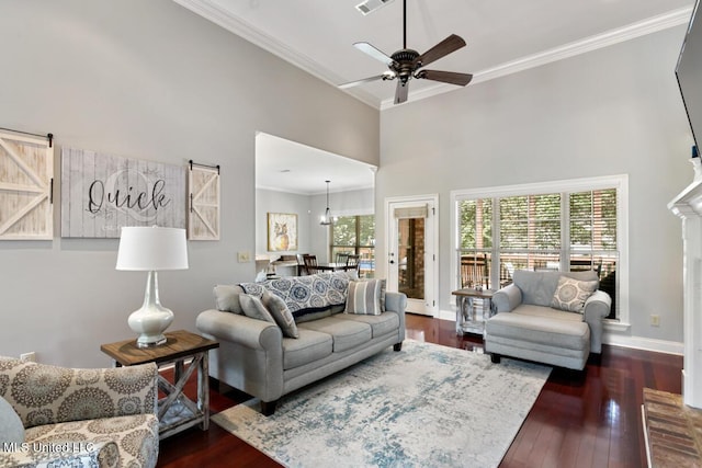 103 Maple Grv, Madison, MS 39110 - living area featuring ornamental molding, a towering ceiling, a ceiling fan, and wood-type flooring