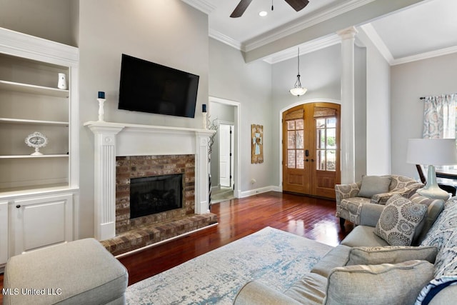 103 Maple Grv, Madison, MS 39110 - living room with a ceiling fan, ornamental molding, wood finished floors, a brick fireplace, and built in features