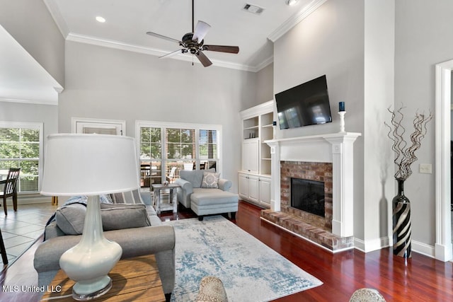 103 Maple Grv, Madison, MS 39110 - living area with plenty of natural light, a ceiling fan, ornamental molding, a brick fireplace, and a high ceiling
