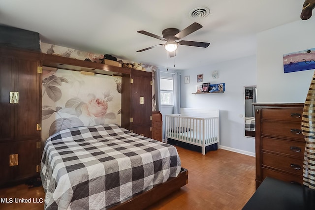 bedroom with dark parquet flooring and ceiling fan