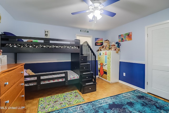 bedroom featuring parquet flooring and ceiling fan