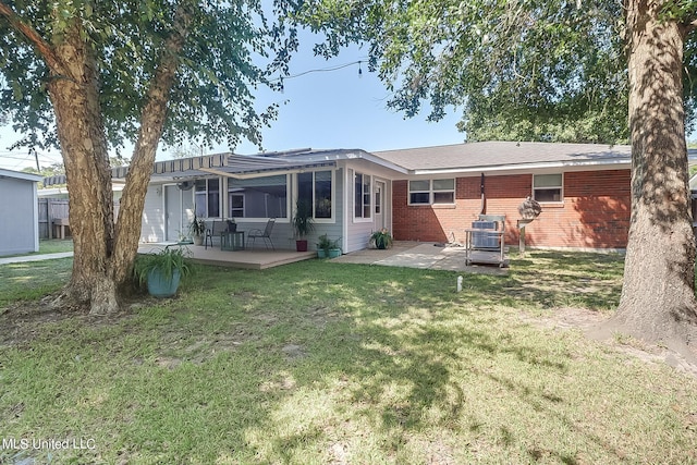 rear view of property featuring a patio area and a lawn