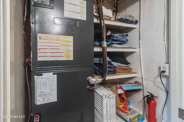 utility room featuring heating unit