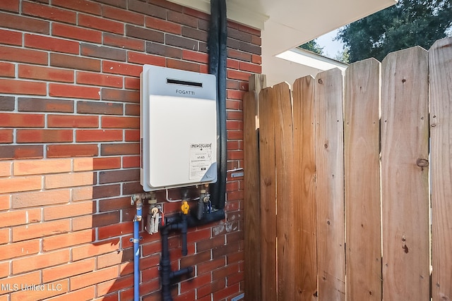 utility room featuring tankless water heater