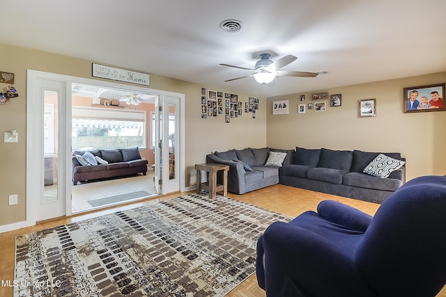 living room featuring light parquet flooring and ceiling fan