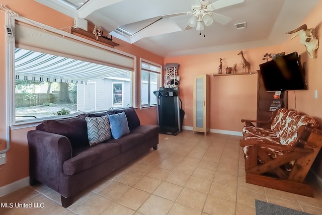 tiled living room with ceiling fan