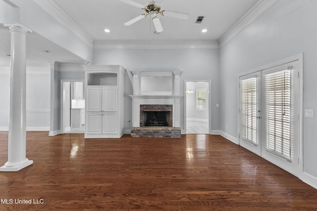 706 Danforth Dr, Madison, MS 39110 - unfurnished living room with decorative columns, a ceiling fan, ornamental molding, a brick fireplace, and wood finished floors