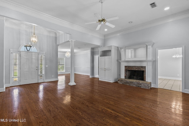706 Danforth Dr, Madison, MS 39110 - unfurnished living room with a chandelier, ceiling fan, wood finished floors, decorative columns, and crown molding