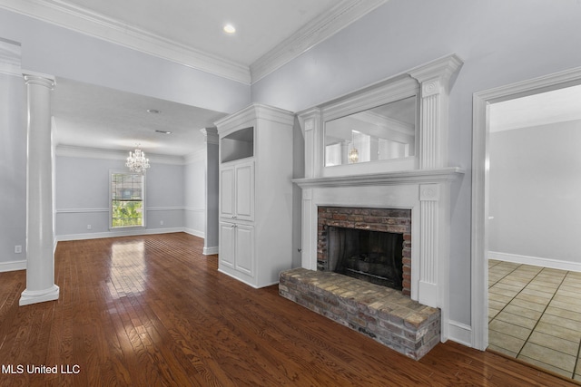 706 Danforth Dr, Madison, MS 39110 - unfurnished living room featuring a brick fireplace, wood finished floors, a chandelier, crown molding, and baseboards