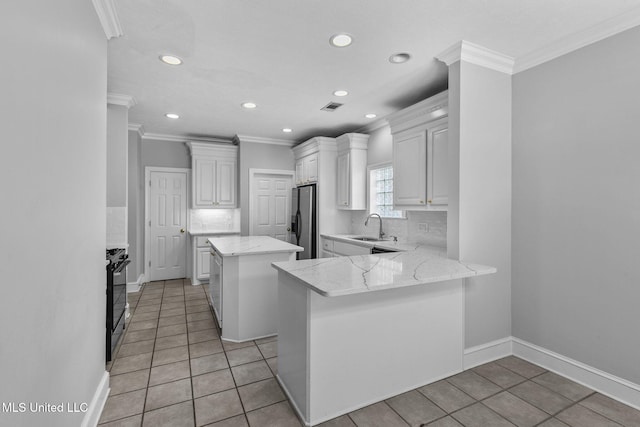 706 Danforth Dr, Madison, MS 39110 - kitchen with crown molding, stainless steel fridge, recessed lighting, a sink, and light tile patterned floors