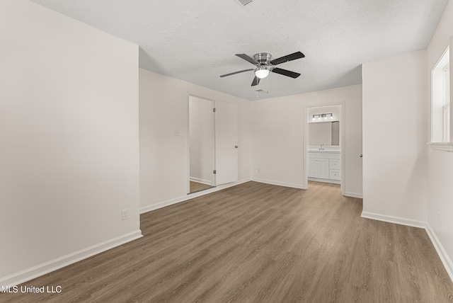 interior space featuring a textured ceiling, ceiling fan, and hardwood / wood-style floors