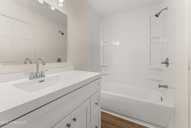 bathroom with vanity, bathing tub / shower combination, and hardwood / wood-style floors