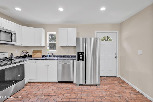 101 30th St, Gulfport, MS 39507 - kitchen featuring stainless steel appliances, a sink, brick patterned flooring, baseboards, and healthy amount of natural light