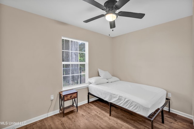 101 30th St, Gulfport, MS 39507 - bedroom featuring baseboards, wood finished floors, and a ceiling fan