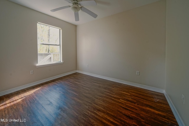 unfurnished room featuring ceiling fan, dark wood-style flooring, and baseboards