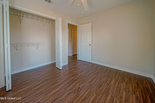 unfurnished bedroom with visible vents, baseboards, dark wood-style floors, ceiling fan, and a closet